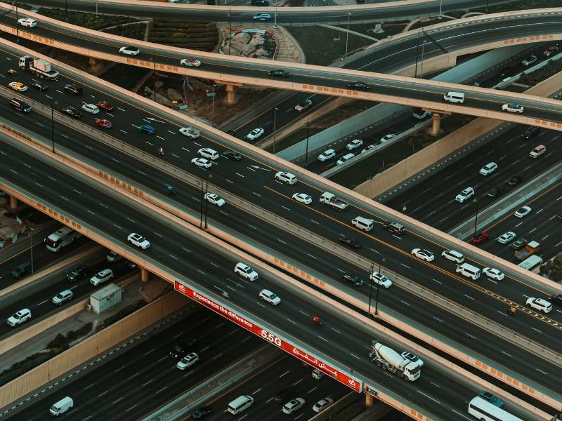 Aerial view of a busy highway interchange illustrating traffic flow and roadway capacity considerations that can influence access for commercial projects.