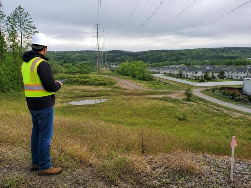 Professional engineer evaluating access, drainage, utilities, and surrounding land uses at a development site in Denver.
