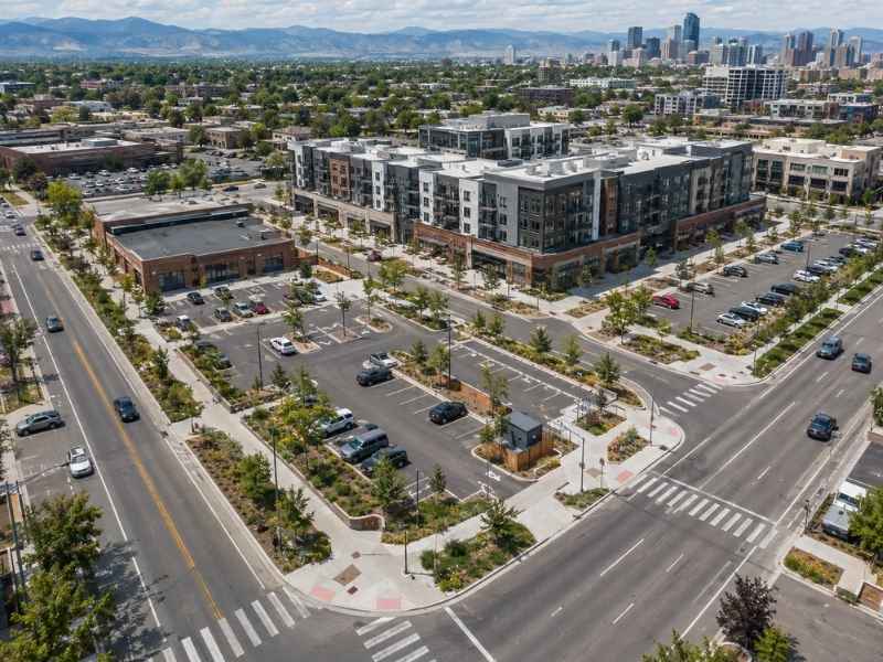Commercial redevelopment site showing parking areas, road access, and surrounding streets in Denver