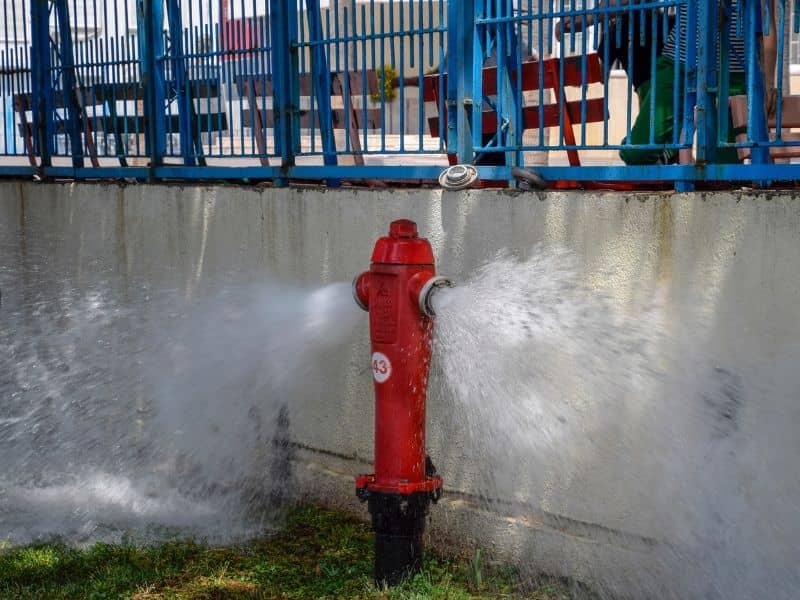 Hydrant flow test measuring water supply and pressure for site design

